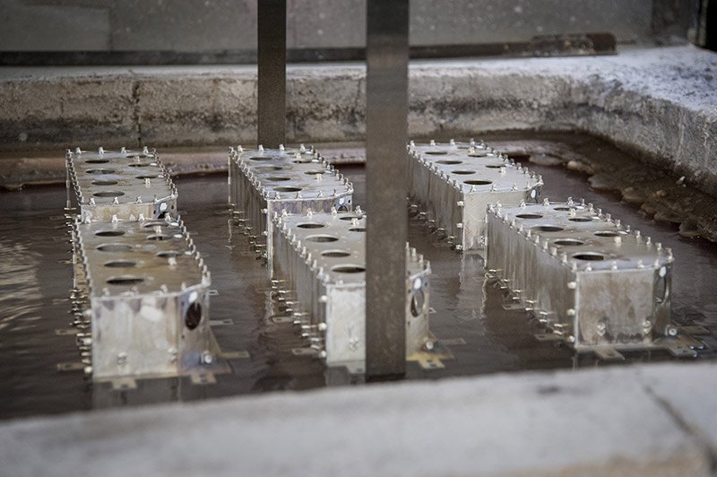 Brazed aluminum assemblies emerging from the dip brazing salt bath